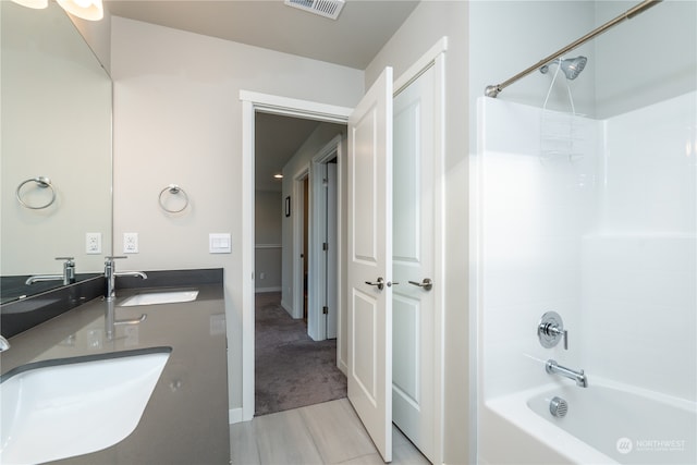 full bath featuring visible vents, tub / shower combination, and a sink