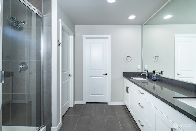 bathroom with double vanity, recessed lighting, a stall shower, a sink, and tile patterned floors