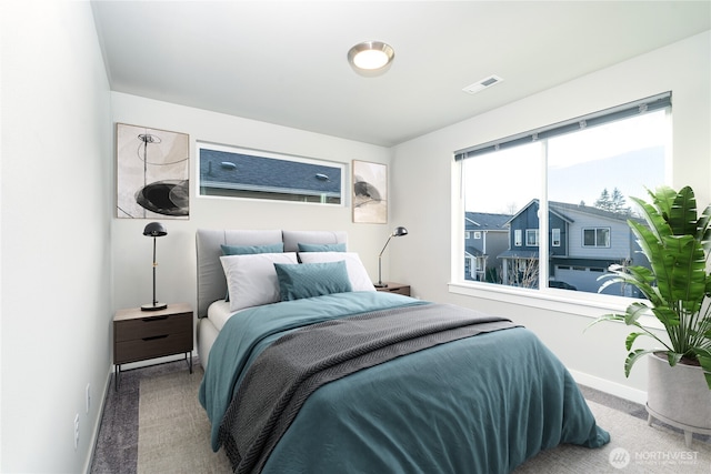 bedroom with carpet, visible vents, and baseboards