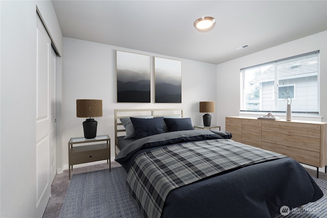 carpeted bedroom with a closet, visible vents, and baseboards