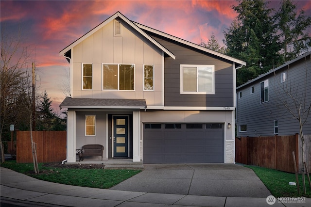 view of front of house featuring driveway, an attached garage, board and batten siding, and fence