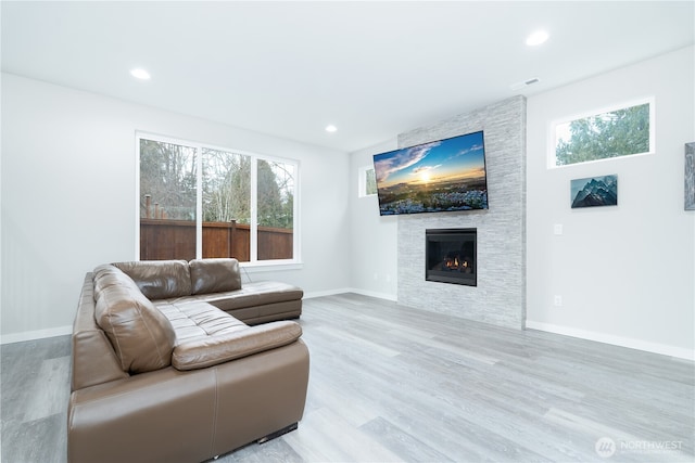 living area featuring recessed lighting, visible vents, and light wood finished floors