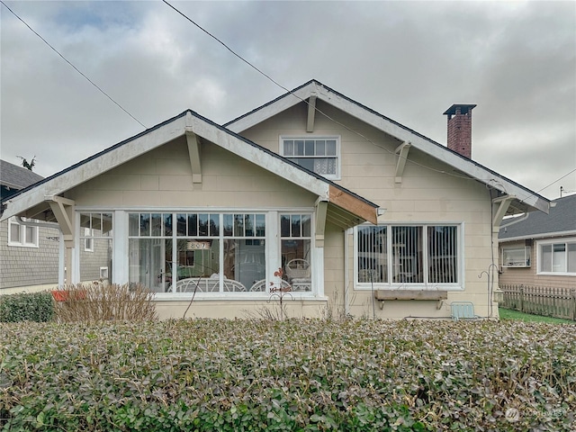 back of property with a sunroom