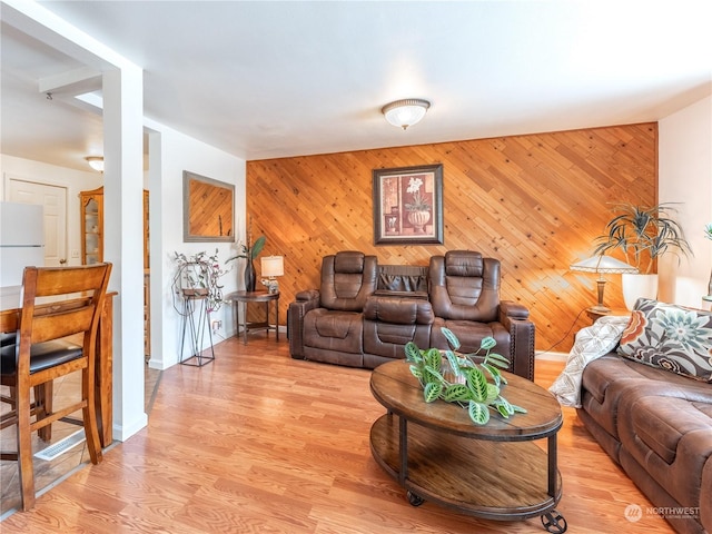 living room featuring wood walls and light wood-type flooring