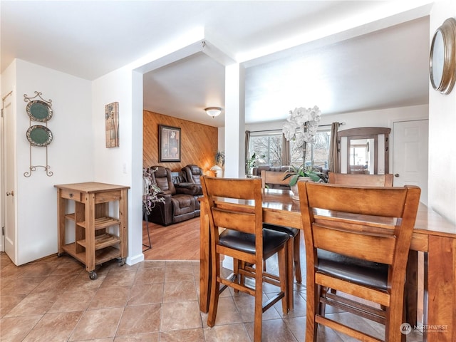 dining room featuring wooden walls