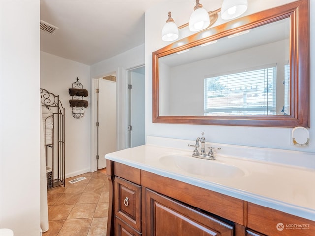 bathroom featuring tile patterned flooring and vanity