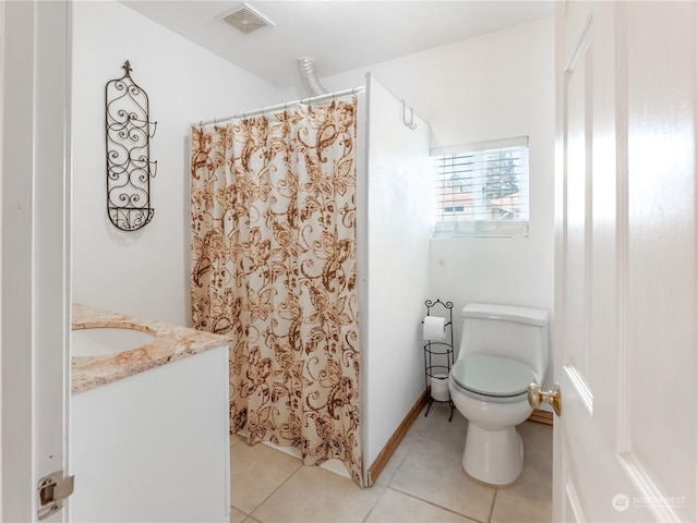 bathroom featuring vanity, tile patterned floors, and toilet