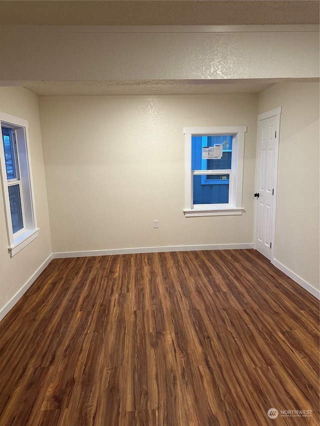 unfurnished room featuring dark hardwood / wood-style floors