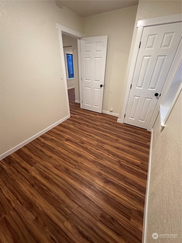 spare room with dark wood-type flooring