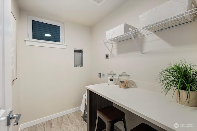 laundry room with hookup for a washing machine, light hardwood / wood-style flooring, and electric dryer hookup