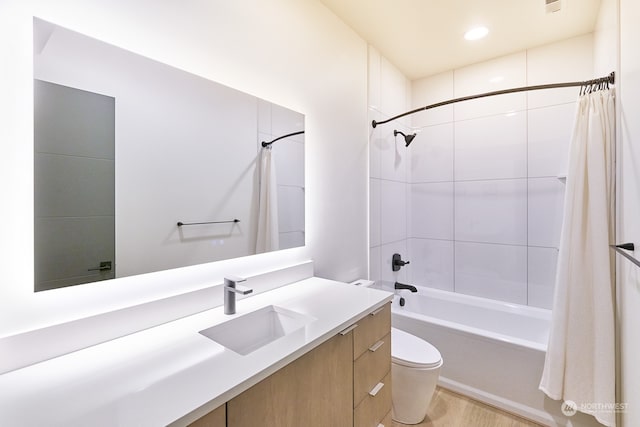 full bathroom with toilet, vanity, and shower / tub combo with curtain