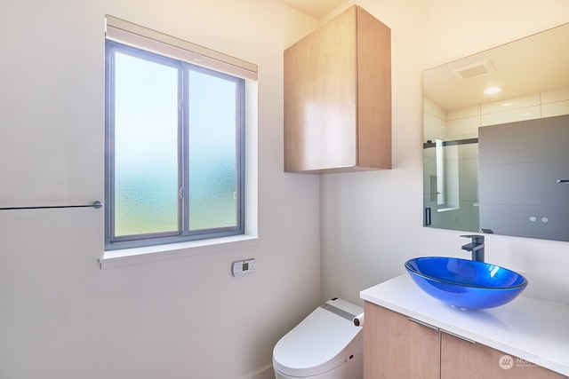 bathroom featuring toilet and vanity