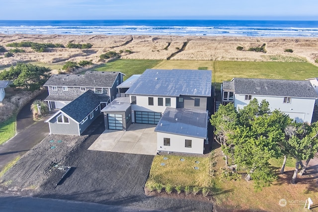 drone / aerial view featuring a water view and a beach view