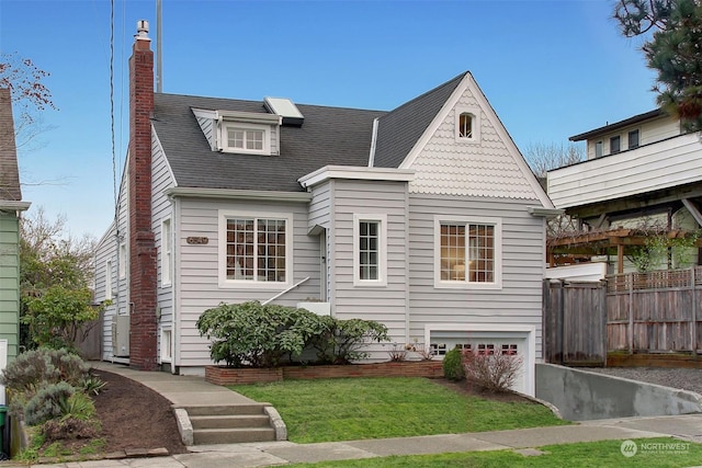 view of front of home with a front yard and a garage