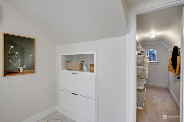 interior space with lofted ceiling and light carpet