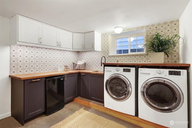 laundry area with light wood-type flooring, separate washer and dryer, and sink