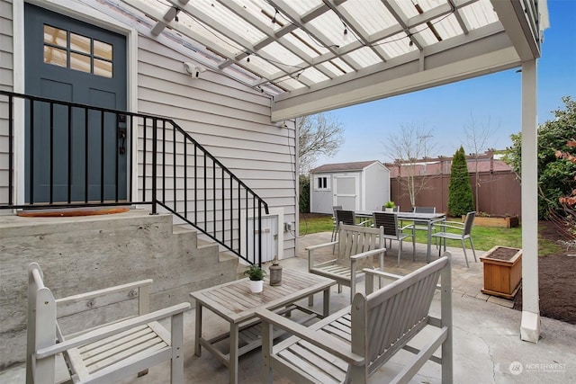 view of patio / terrace with a pergola and a storage shed