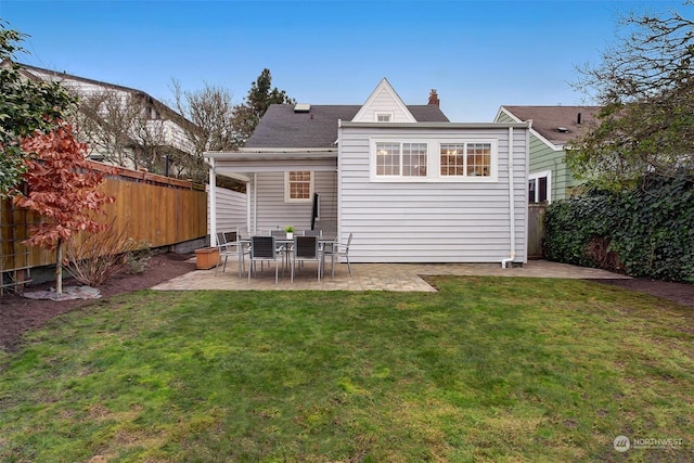 back of house with a yard and a patio area