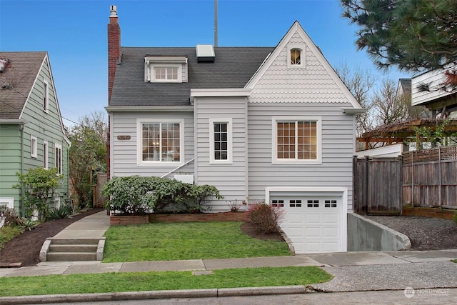 view of front of home with a front yard and a garage