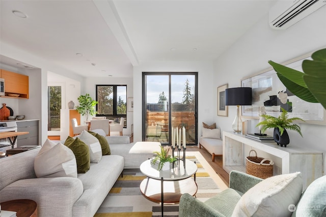 living room with light hardwood / wood-style flooring and an AC wall unit