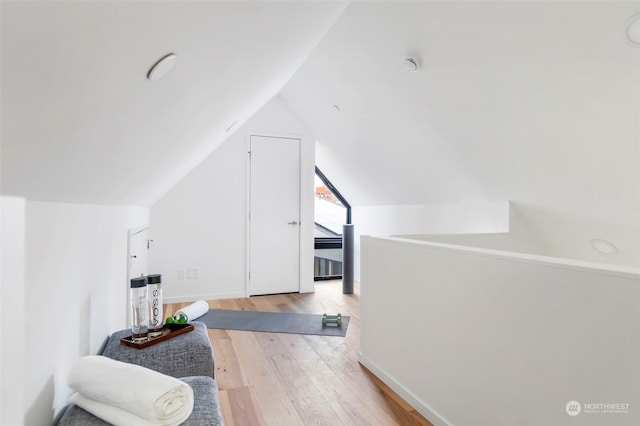 bonus room featuring lofted ceiling and light hardwood / wood-style flooring