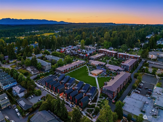 aerial view at dusk featuring a mountain view