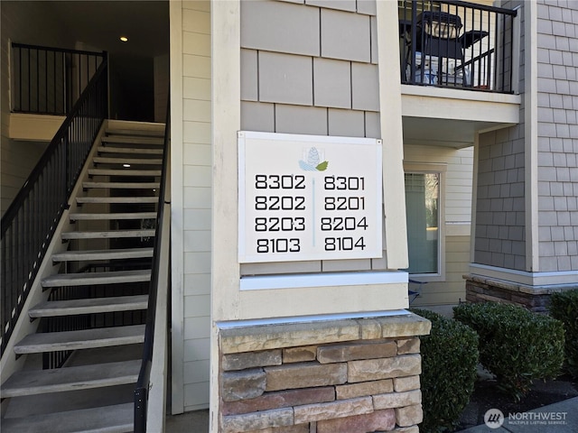 exterior space featuring stone siding and stairs