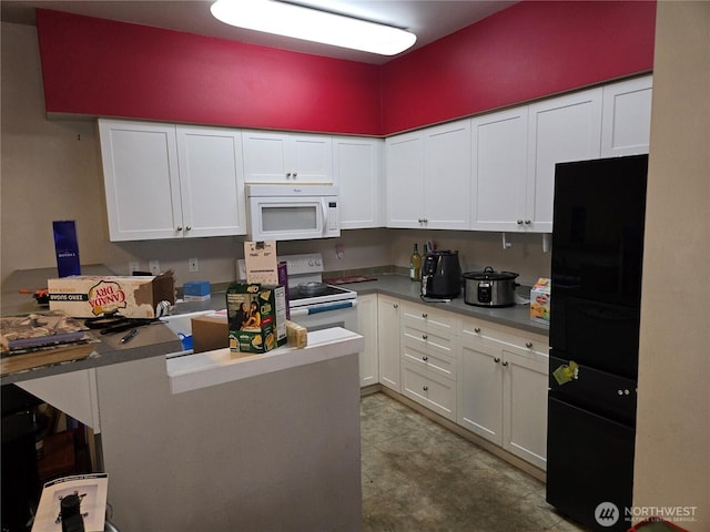 kitchen featuring a peninsula, white appliances, light countertops, and white cabinets