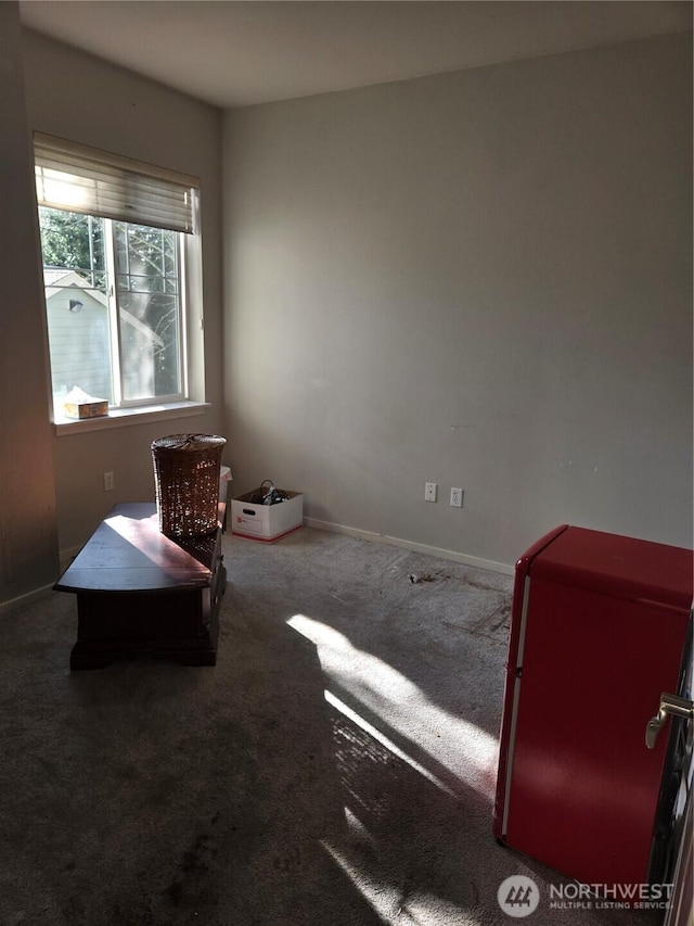 interior space with carpet flooring and baseboards