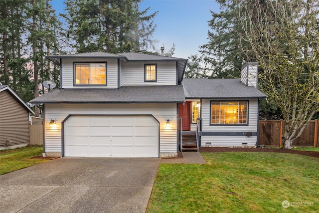 split level home with a lawn and a garage