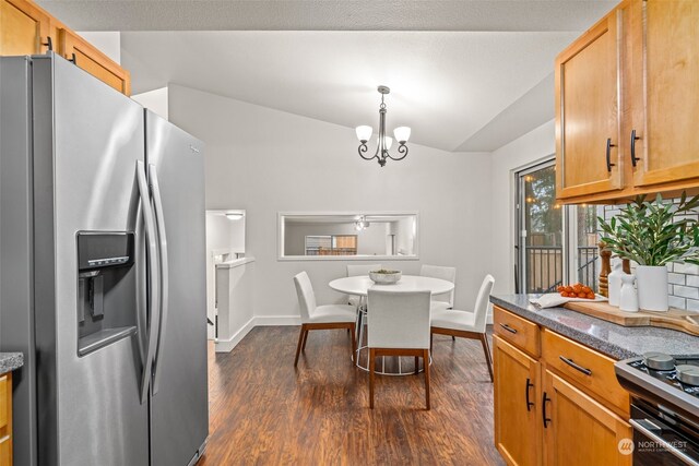 kitchen with a notable chandelier, stainless steel fridge, pendant lighting, dark hardwood / wood-style floors, and stove