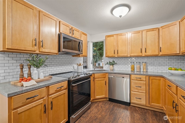 kitchen featuring sink, decorative backsplash, and appliances with stainless steel finishes