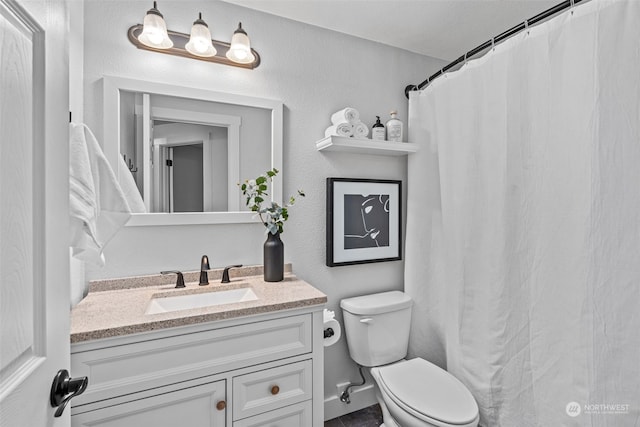 bathroom featuring toilet and vanity