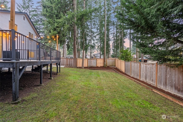 yard at dusk with a wooden deck