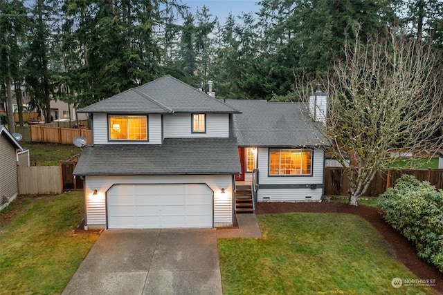 view of front of home with a front lawn and a garage