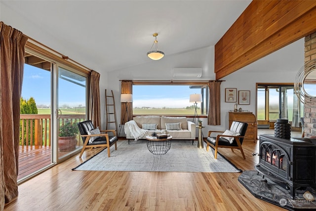 living room featuring lofted ceiling, light wood-type flooring, a wall mounted air conditioner, and a wood stove