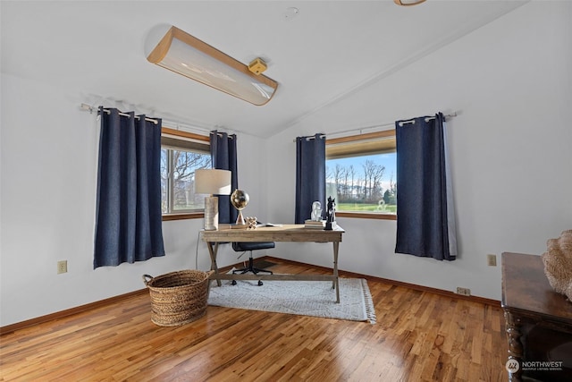 office area with lofted ceiling, hardwood / wood-style flooring, and a healthy amount of sunlight