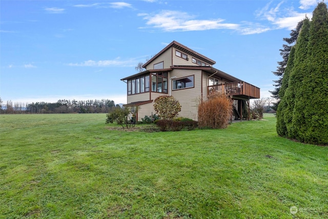 view of side of home featuring a deck and a yard