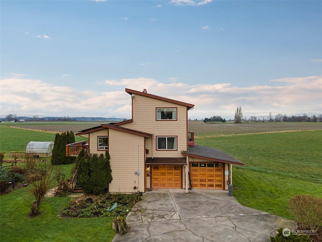 front facade with a rural view, a deck, a front yard, and a garage