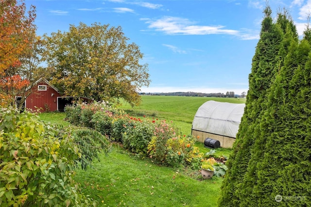 view of yard with an outbuilding and a rural view