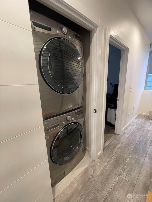 washroom with stacked washer and dryer