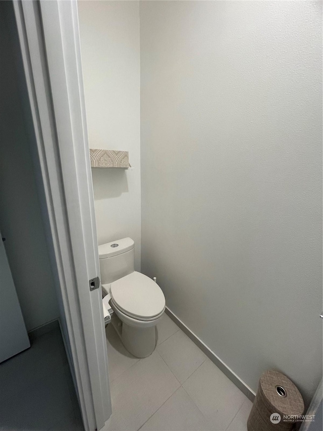 bathroom with toilet and tile patterned floors