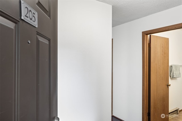 corridor with a textured ceiling