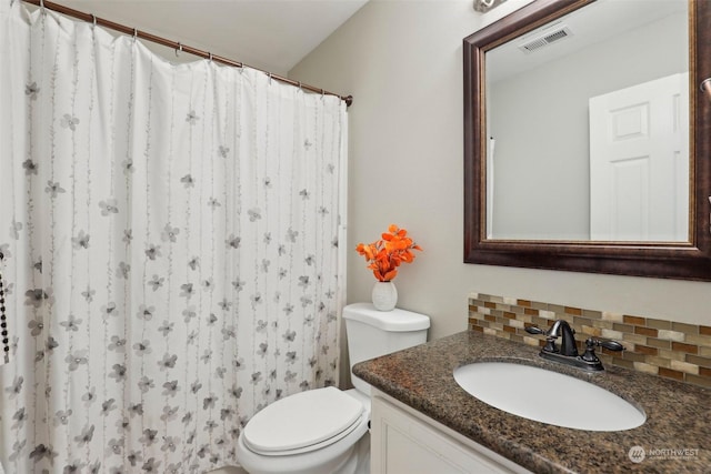 bathroom with vanity, toilet, walk in shower, and decorative backsplash