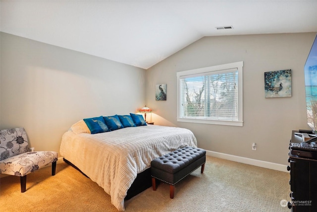 bedroom with light colored carpet and vaulted ceiling