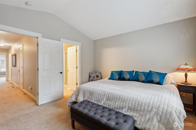 carpeted bedroom with lofted ceiling