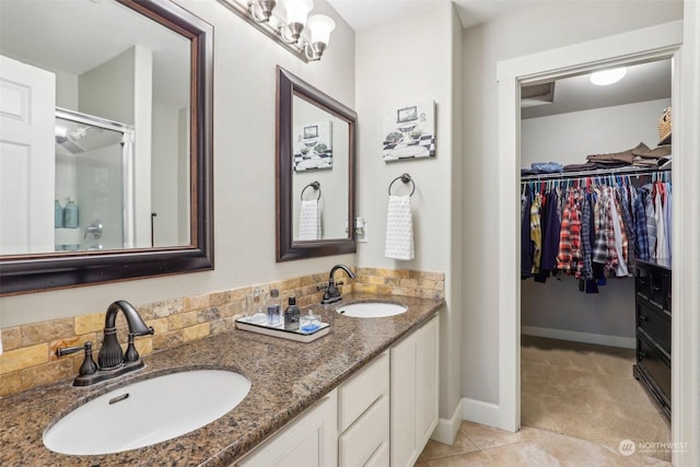 bathroom with tile patterned floors, vanity, and a shower with door