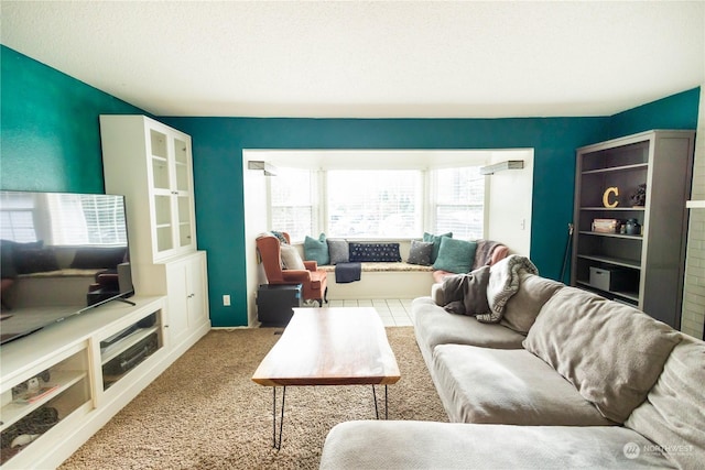 living room with a textured ceiling and light carpet