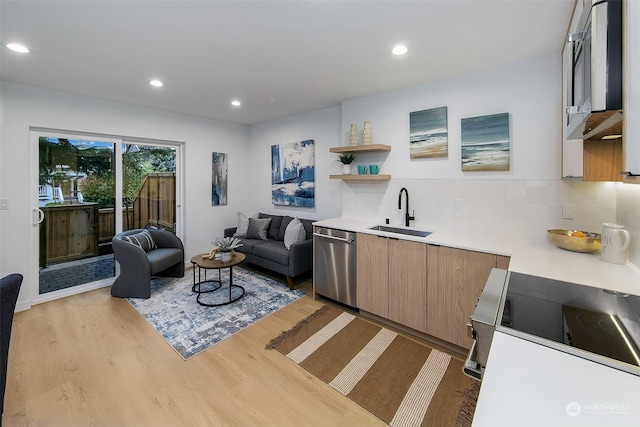 living room with light hardwood / wood-style flooring and sink