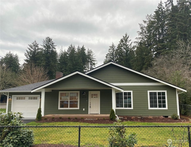 ranch-style home featuring a front lawn and a garage